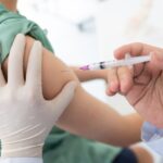 Close Up Of A Doctor Making A Vaccination In The Shoulder Of Patient, Flu Vaccination Injection On A