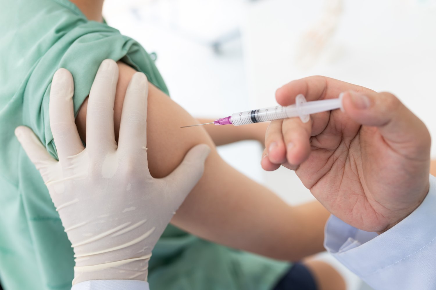 Close Up Of A Doctor Making A Vaccination In The Shoulder Of Patient, Flu Vaccination Injection On A